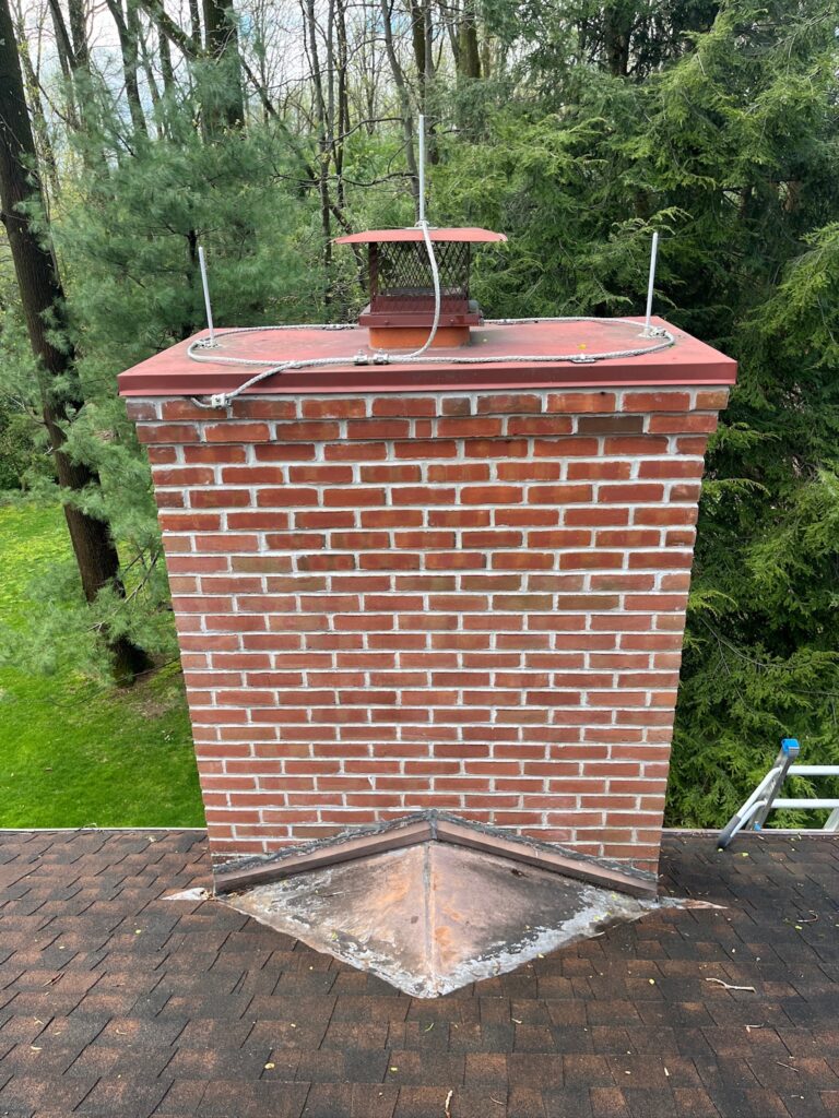 Original Photo- Red Chimney Cap on Roof-Chimney Cap Builders