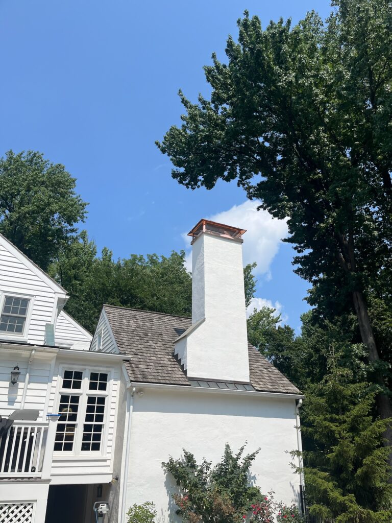 Chimney Cap on White Brick House